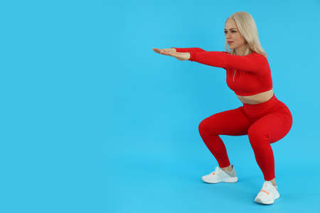 Concept of healthy lifestyle with sporty woman on blue background