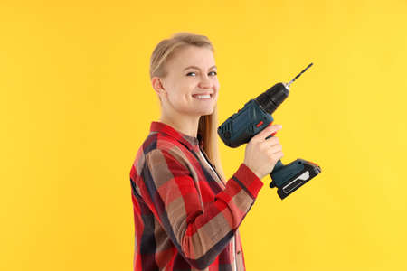 Concept of occupation, young woman on yellow background