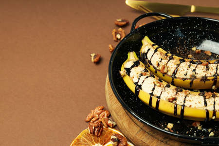 Banana dessert on brown background, space for textの写真素材