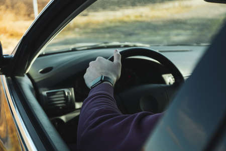 Odessa, Ukraine - 20 january 2022: Concept of travel and adventure, man sit in carの写真素材