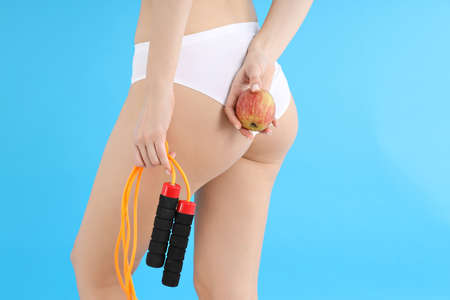 Concept of weight loss, young woman body on blue backgroundの写真素材