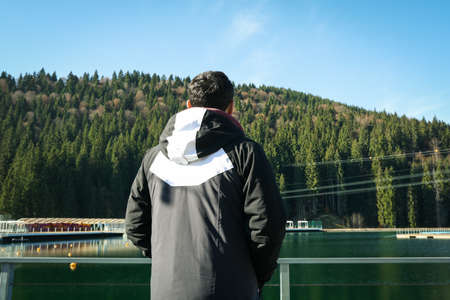 Man standing near lake in Carpathian mountainsの写真素材