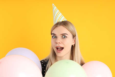 Concept of Happy Birthday with attractive girl on yellow backgroundの写真素材