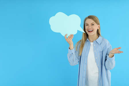 Young woman with speech bubble on blue background