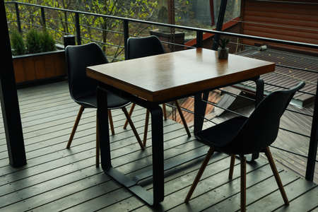 Table with chairs in stylish wooden restaurant