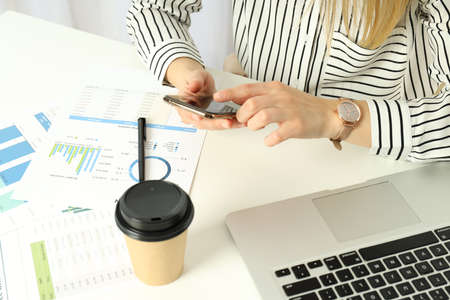 Young business woman sitting on workplace or work table