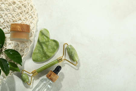 Face care concept with gua sha, face roller and cosmeticの写真素材