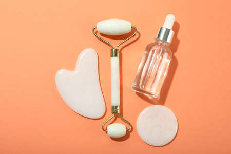 Face care concept with gua sha, face roller and cosmeticの写真素材