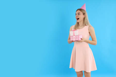 Concept of Happy Birthday with attractive girl on blue background