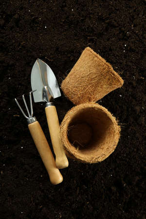 Accessories and tools for gardening on soil backgroundの写真素材