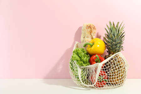String bag with grocery on two tone backgroundの写真素材