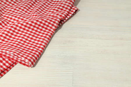 Red and white checkered tablecloth on wooden backgroundの写真素材