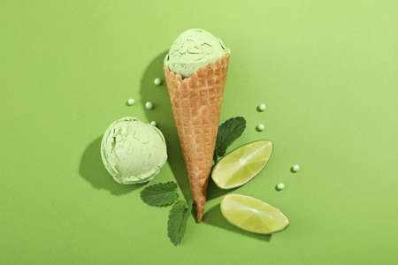Lime and mint ice cream on green background