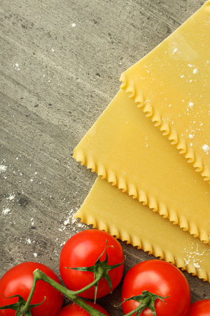 Concept of cooking, cooking lasagna composition on gray textured backgroundの写真素材
