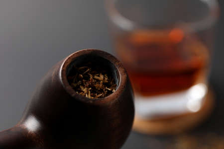 Smoking pipe with tobacco, close up and selective focus