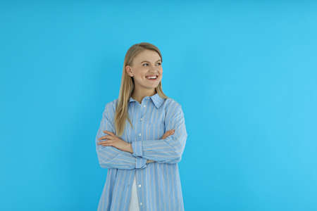 young woman looking at something on blue background