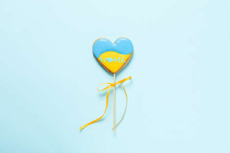 Cookie with Ukrainian flag colors and text HOME on blue backgroundの写真素材