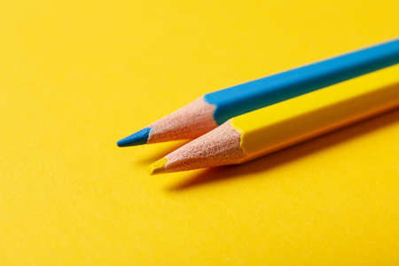 Pencils in colors of Ukrainian flag on yellow backgroundの写真素材