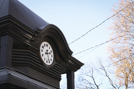 Clock on building in sunny autumn day