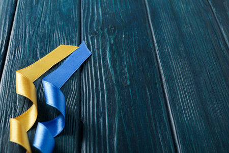 Ribbons in Ukrainian flag colors on wooden backgroundの写真素材