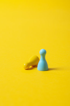 Figurines in Ukrainian flag colors on yellow backgroundの写真素材