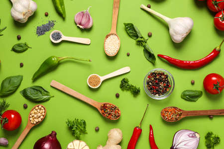 Different ingredients for cooking on green background