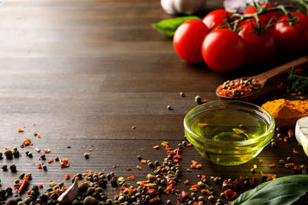 Different cooking ingredients and spices on wooden backgroundの写真素材