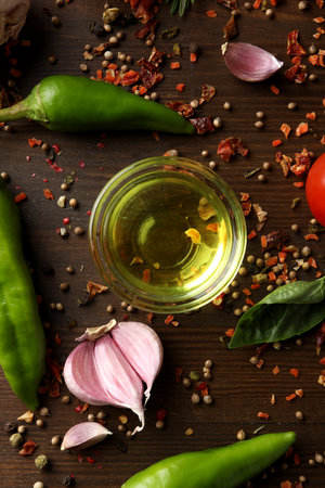 Different cooking ingredients and spices on wooden backgroundの写真素材