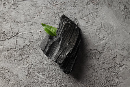 natural wood charcoal on gray textured backgroundの写真素材