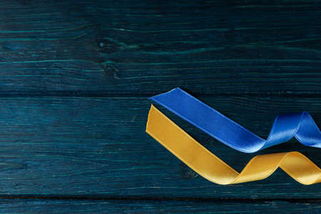 Ribbons in Ukrainian flag colors on wooden backgroundの写真素材