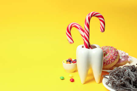 Concept of food bad for teeth on yellow backgroundの写真素材