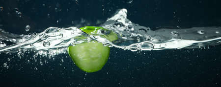 Concept of summer, cucumber slice in waterの写真素材
