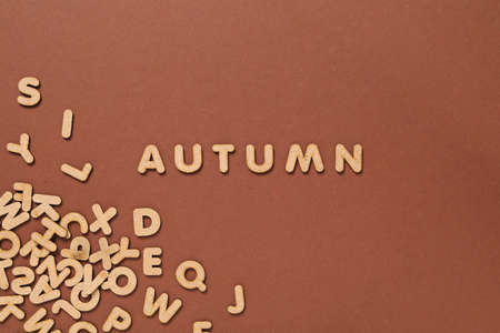 Word Autumn and letters on brown backgroundの写真素材