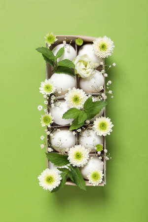 Concept of spring, eggs with flowers, top view