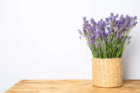 Wicker pot with lavender on wooden backgroundの写真素材