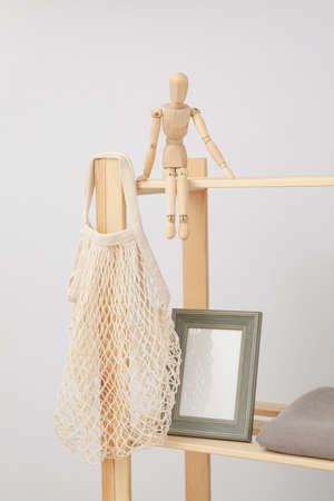 Wooden shelving with different accessories and blank photo frameの写真素材