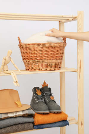 Wooden shelving with clothes, autumn season clothesの写真素材