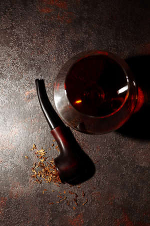 Composition of relaxation with smoking pipe and whiskeyの写真素材