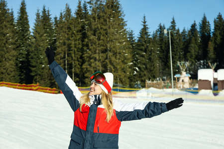 Happy female skier with goggles in mountain resortの写真素材