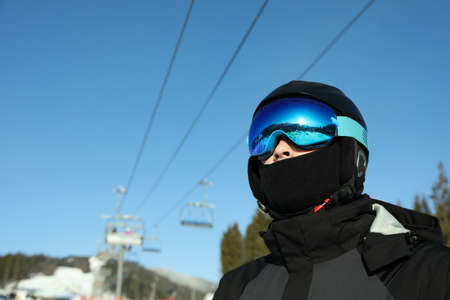 Male skier in ski helmet and goggles in mountain resortの写真素材