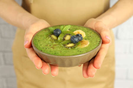 Woman in apron with smoothie with different ingredientsの写真素材