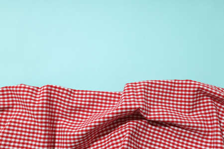Red and white checkered tablecloth on blue backgroundの写真素材