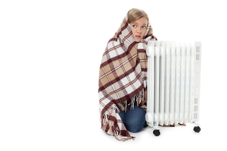 Woman with plaid and heater isolated on white backgroundの写真素材