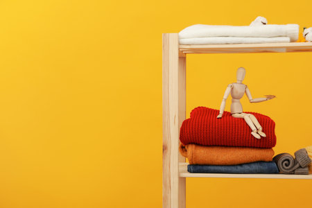 Wooden shelving with clothes, autumn season clothesの写真素材