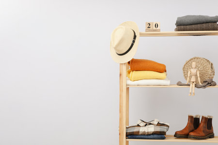 Wooden shelving with clothes, concept of autumn season clothesの写真素材