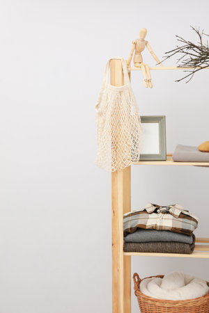 Wooden shelving with clothes, concept of autumn season clothesの写真素材