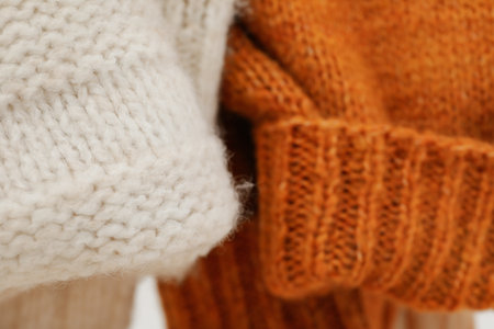 Hanging sweaters, concept of autumn season clothesの写真素材