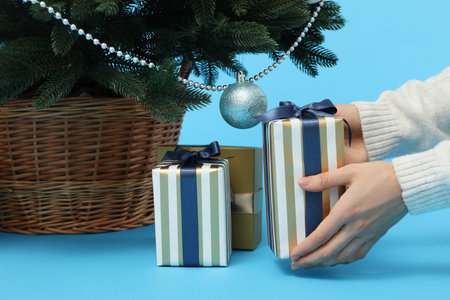 Concept of Christmas and Happy New Year, female hands holding gift box