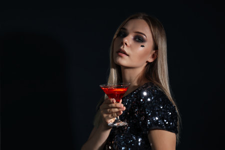 Concept of Halloween, young woman on dark backgroundの写真素材