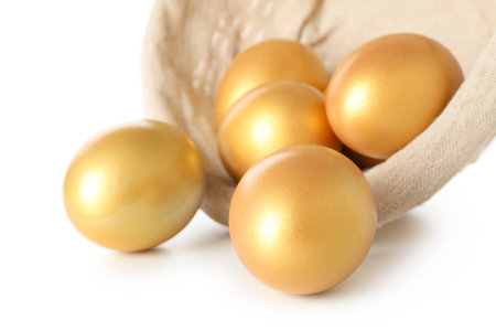 Concept of Richness, golden eggs, isolated on white backgroundの写真素材